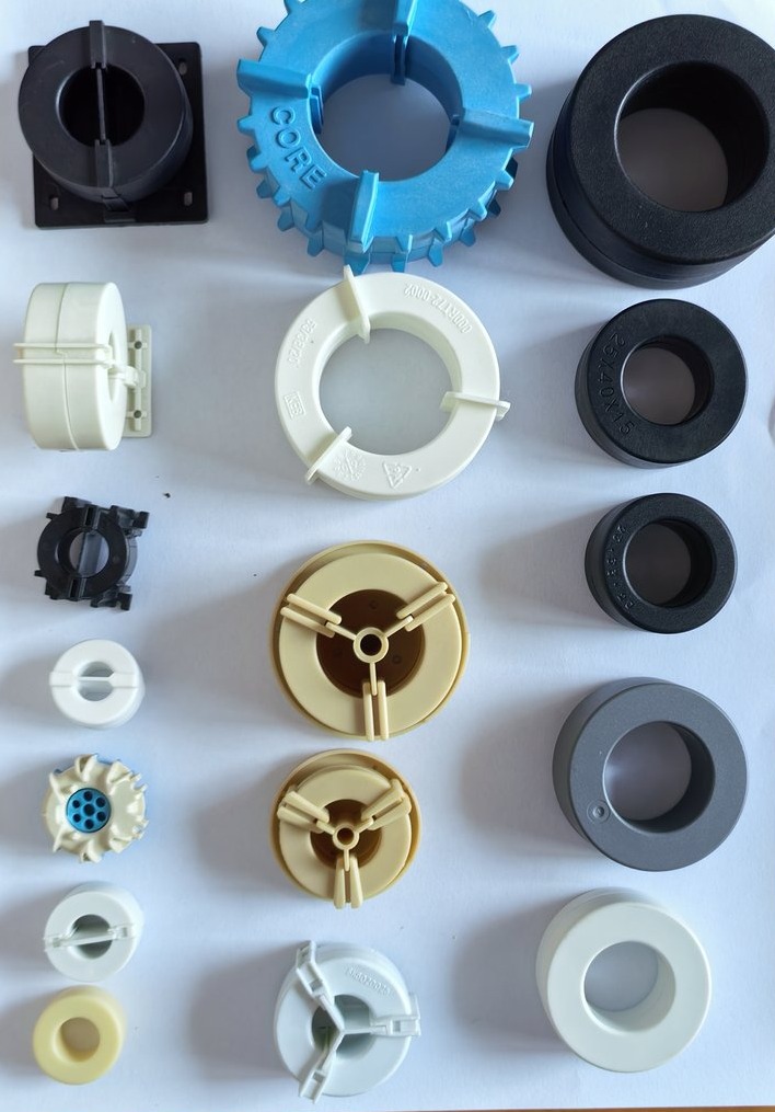 Plastic cases and bases for cased nanocrystalline cores on the case line